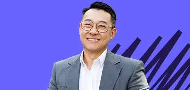 A man in tuxedos wearing glasses.