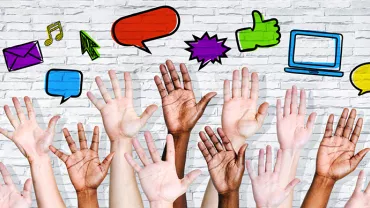 Hands reaching up with various social media icons above on a brick background.
