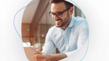 Person smiling while looking at a tablet
