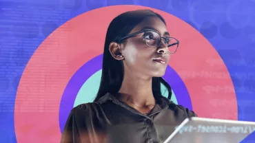Person holding a tablet with a colorful digital background.