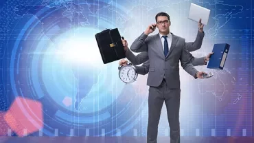 Person in a suit multitasking with various office items in hand.