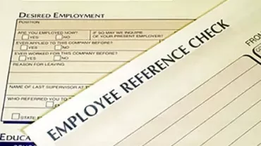 Close-up of employee reference check form and employment application.