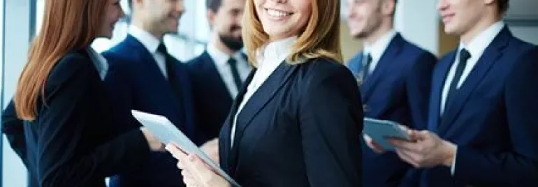 Professional group in conversation with notepads.