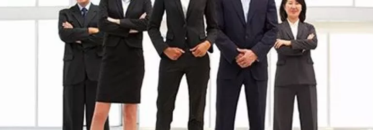 Groupe de professionnels debout avec assurance dans un bureau.