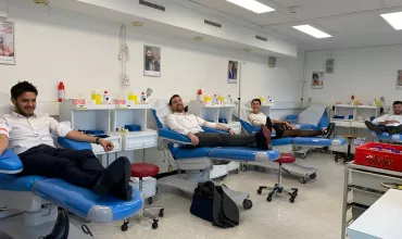 People donating blood in a clinic setting.
