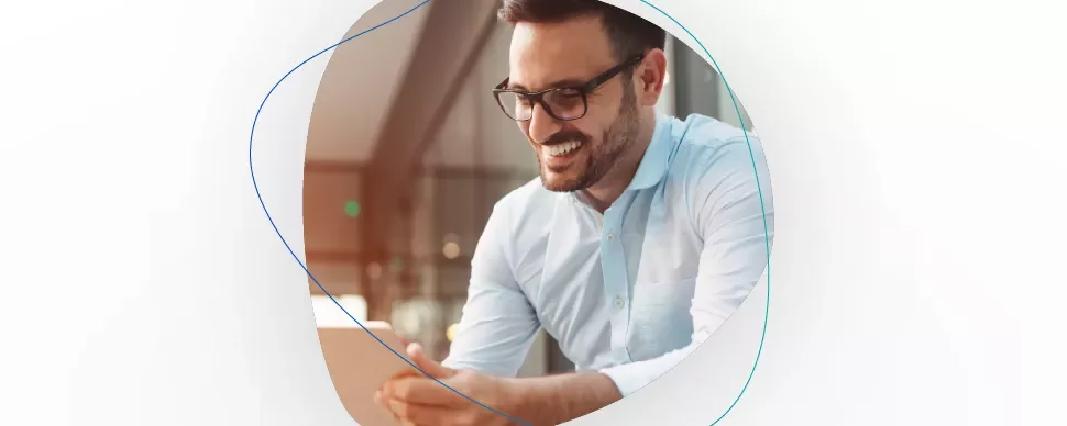 Person smiling while looking at a tablet